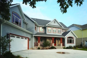 The front of a house has newly installed windows by Highland siding company.