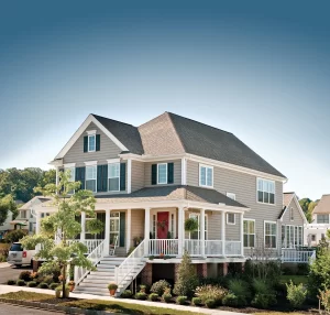 A large house exterior shows updated windows, gutters, and siding from Dyer exterior contractor.
