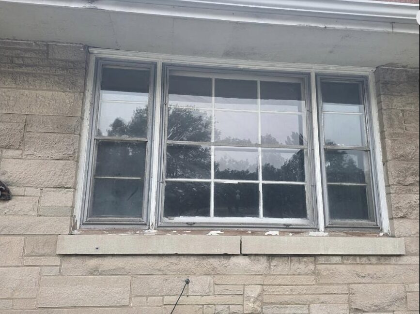 Hammond, IN window replacement project - before, aged steel three-lite window in limestone home