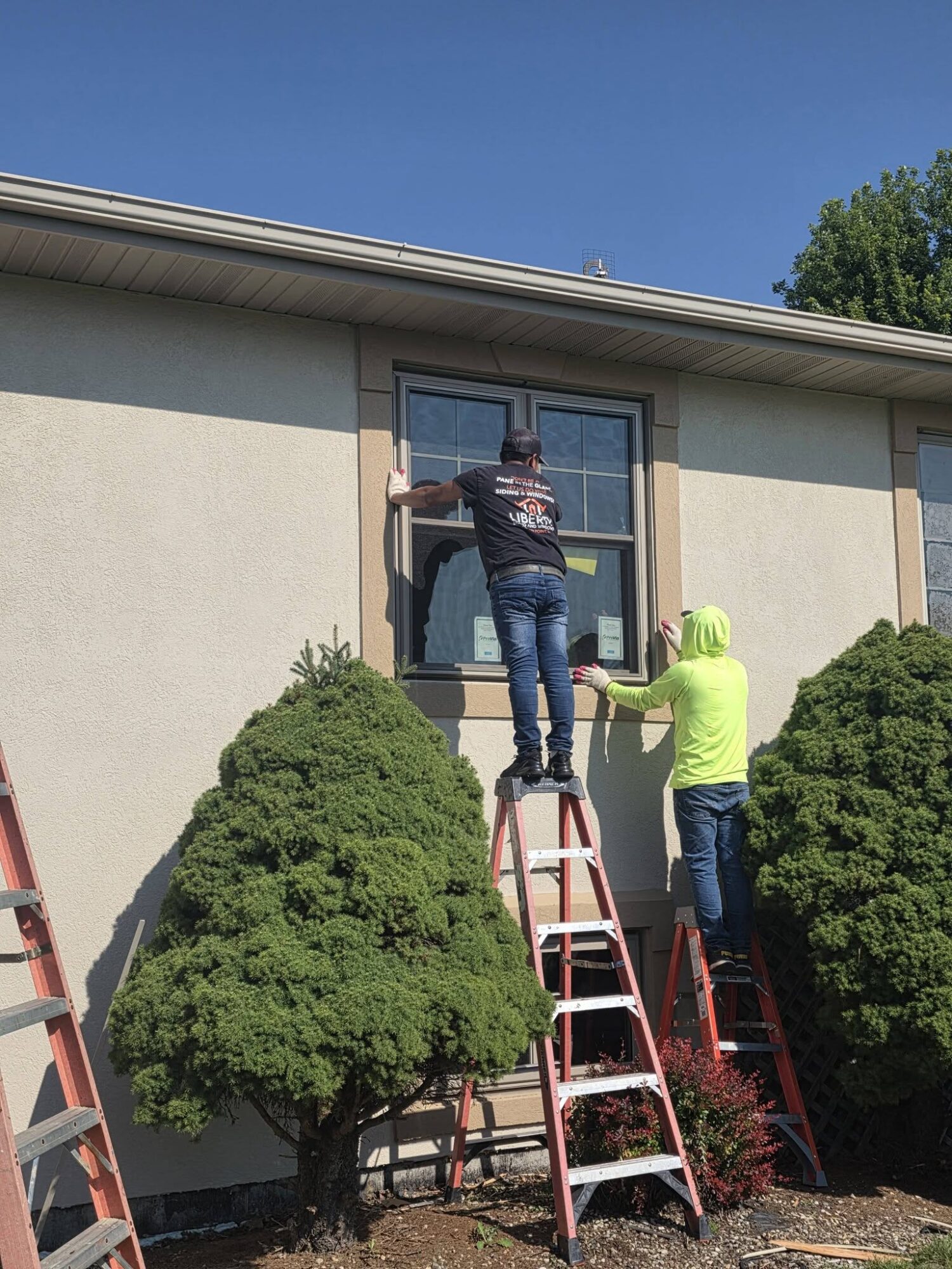 During - installers setting a ProVia Endure window in Crown Point, IN
